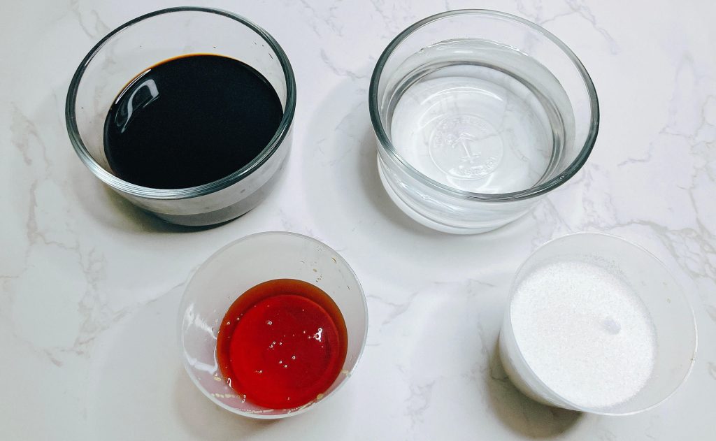 Ingredients for teriyaki sauce including soy sauce, golden syrup, sugar, and water – no mirin or sake