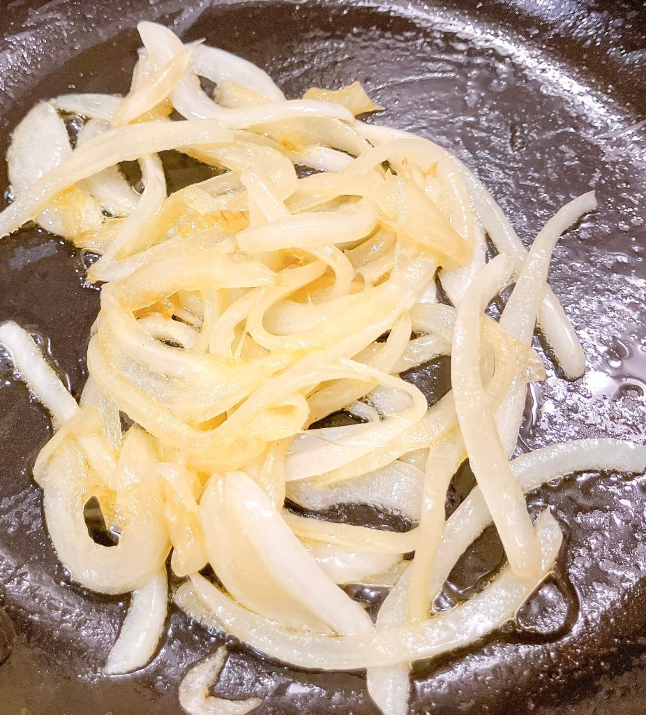 Sautéing sliced onions with butter for teriyaki onion gravy