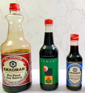 Soy sauce bottle comparison – regular soy sauce, tamari, and gluten-free soy sauce, on white background