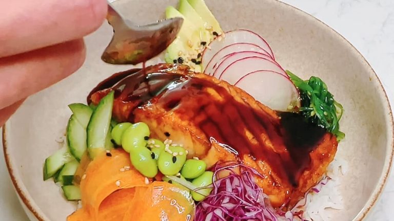 Homemade teriyaki sauce being poured over a Japanese-inspired rice bowl