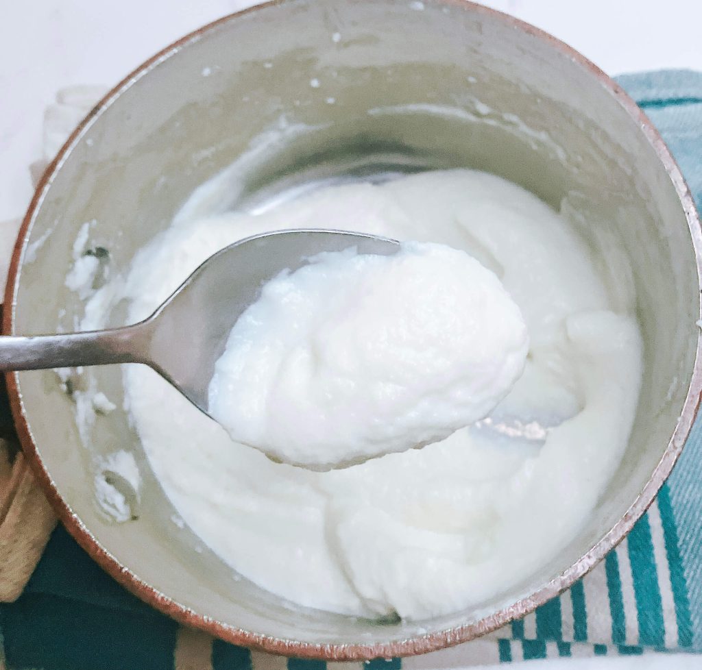 Smooth and creamy cauliflower mash scooped in a bowl — low-carb and dairy-rich side dish alternative.