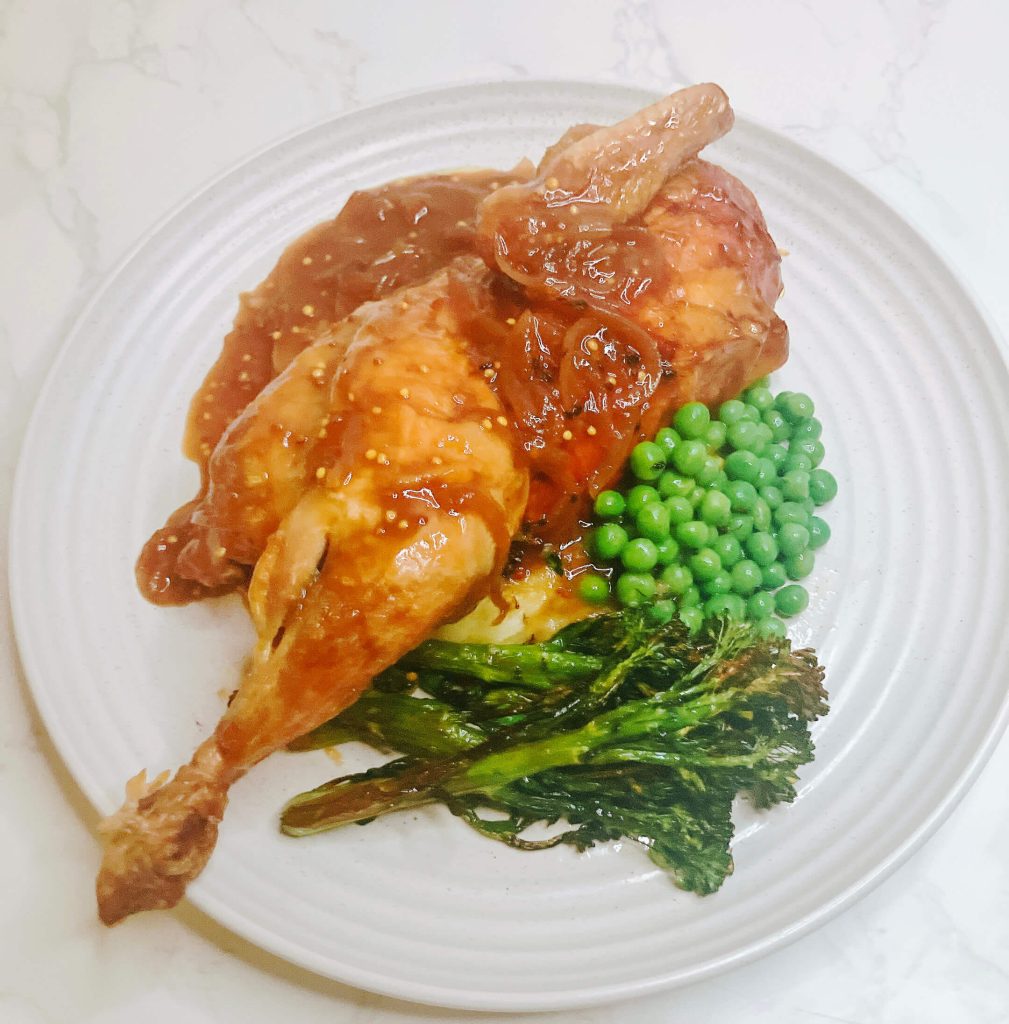 Roast chicken with mashed potatoes, peas, and broccolini, topped with homemade teriyaki onion gravy — a flavorful serving variation.