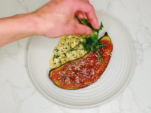 Add fresh herbs to red miso-glazed eggplant served with turmeric cauliflower rice"