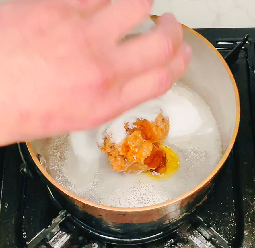Adding all miso sauce ingredients into a pot to cook for cauliflower fried rice with miso eggplant.