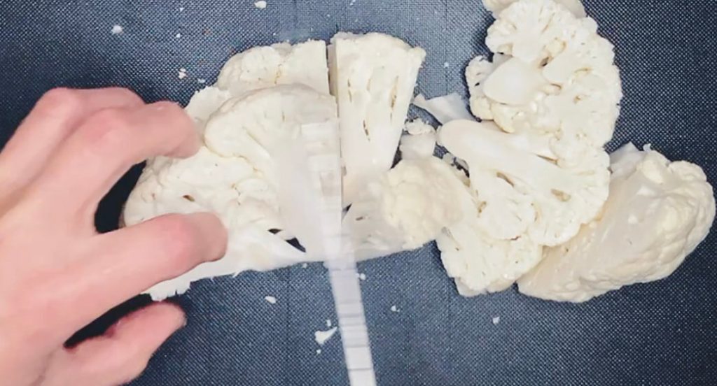 Cauliflower cut into small florets, ready to be pulsed in a food processor to make keto cauliflower rice