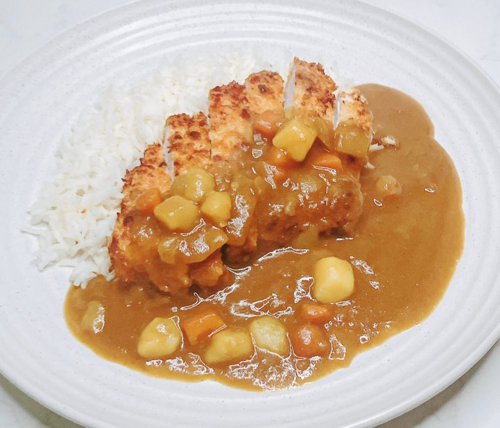 Chicken katsu served with Japanese curry roux and rice, classic version.