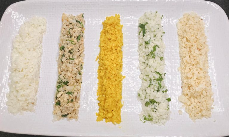 Five cauliflower rice variations on a white plate – plain, fried, turmeric, cilantro lime, and coconut.”