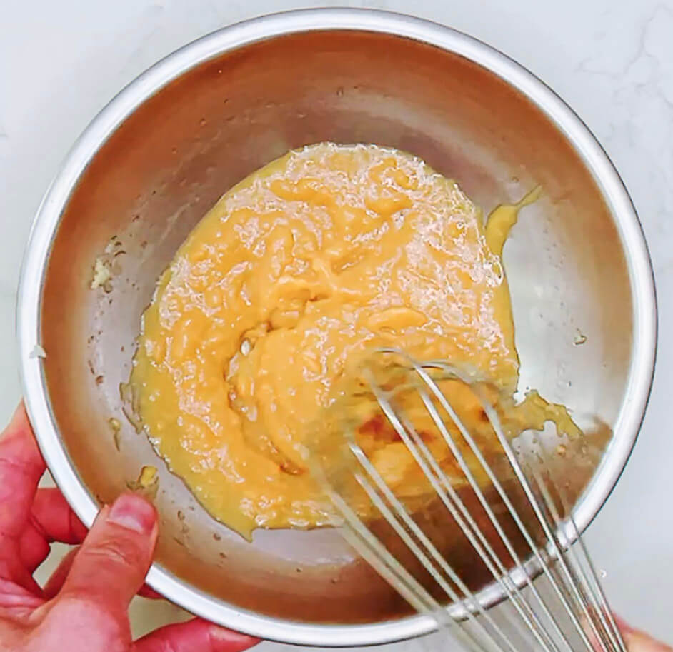 Whisking miso marinade ingredients together in a bowl until smooth.