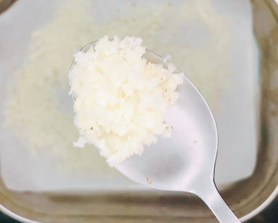 Oven cauliflower rice cooked covered, showing a softer steamed texture with no golden edges.