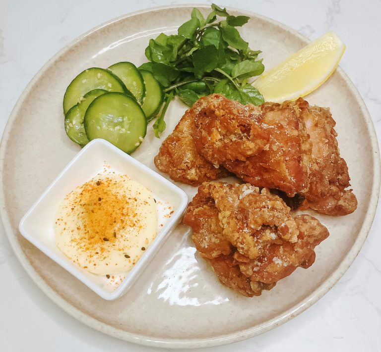 Crispy air fryer karaage chicken with quick cucumber pickles on a plate