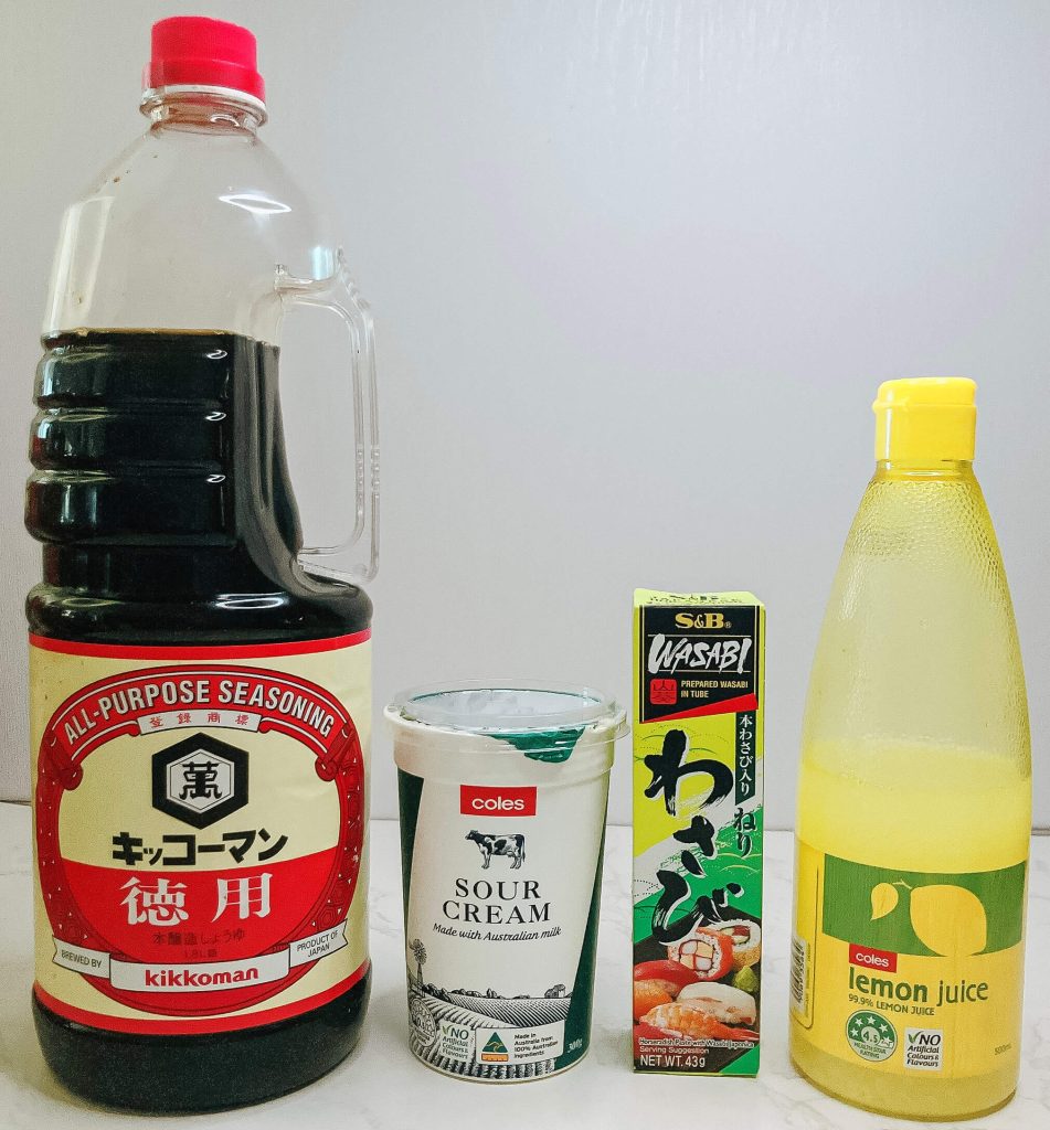 Wasabi paste, sour cream, soy sauce, and lemon – ingredients for a wasabi sour cream dipping sauce for karaage chicken