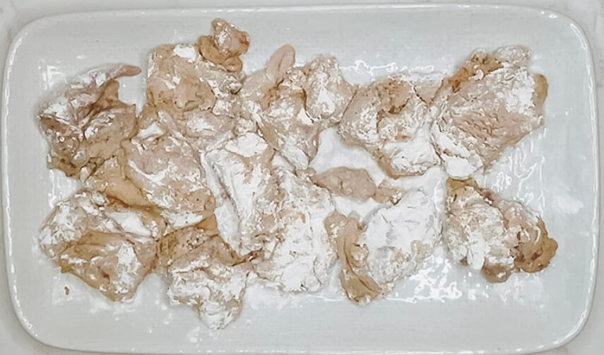 Chicken pieces resting after the first starch coating for karaage chicken.