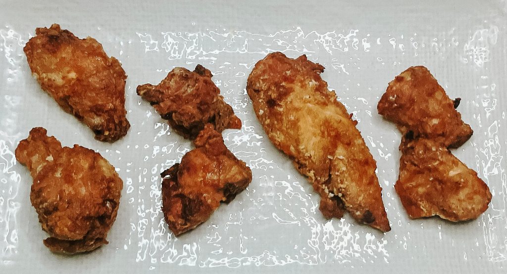Fried karaage chicken cuts lined up – wing, thigh, tenderloin, and breast, from left to right.