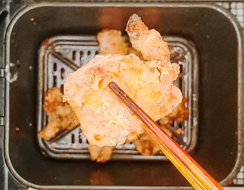 Finished karaage chicken after the second fry, golden and crispy in the air fryer basket."