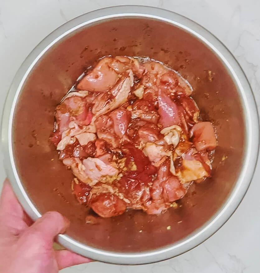 Chicken thigh pieces resting in karaage marinade with tamari, sake, ginger, garlic, oil, salt, and sugar