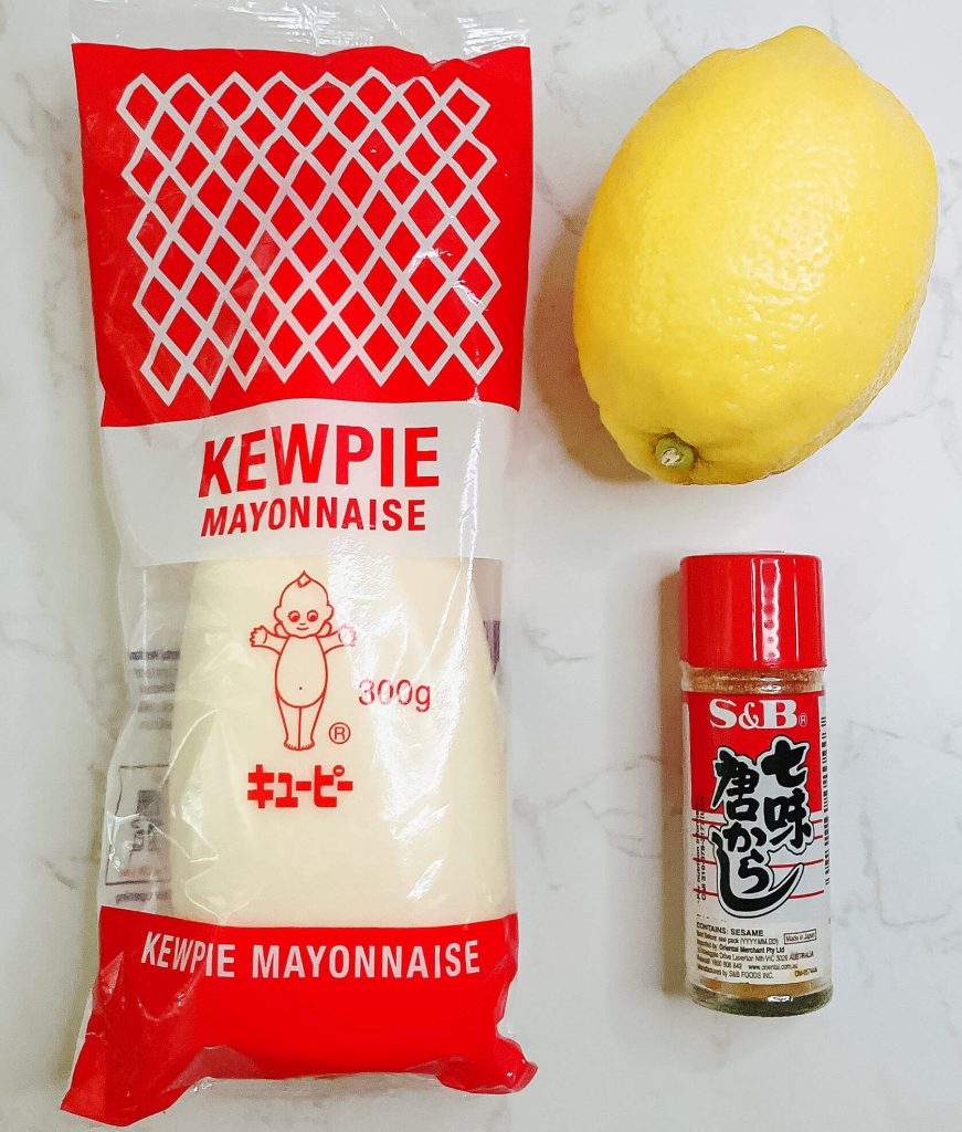 Kewpie mayonnaise, shichimi togarashi, and lemon – classic Japanese condiments often served with karaage chicken.