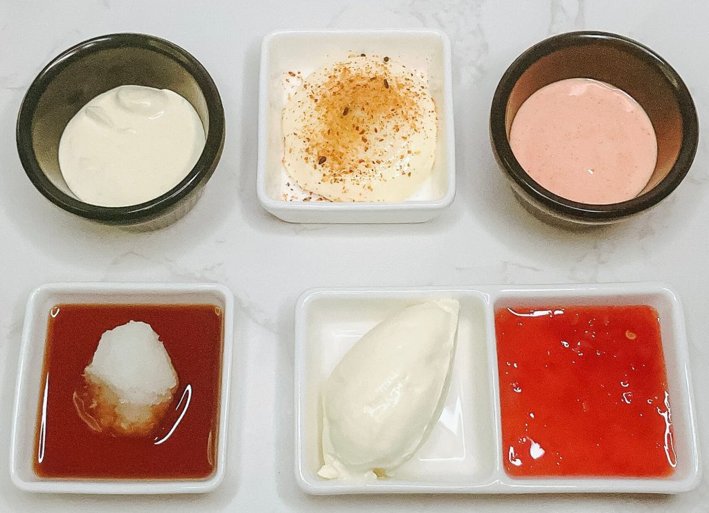 Five dipping sauces for karaage chicken – shichimi mayo, sweet chili sour cream, wasabi sour cream, spicy sambal mayo, and oroshi ponzu