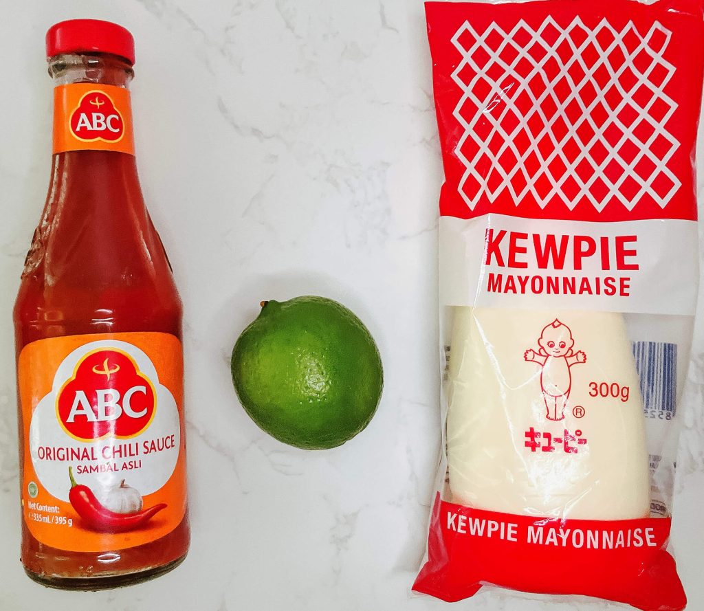 "Sambal chili sauce, lime, and Kewpie mayonnaise – ingredients for spicy mayo dipping sauce for karaage chicken.