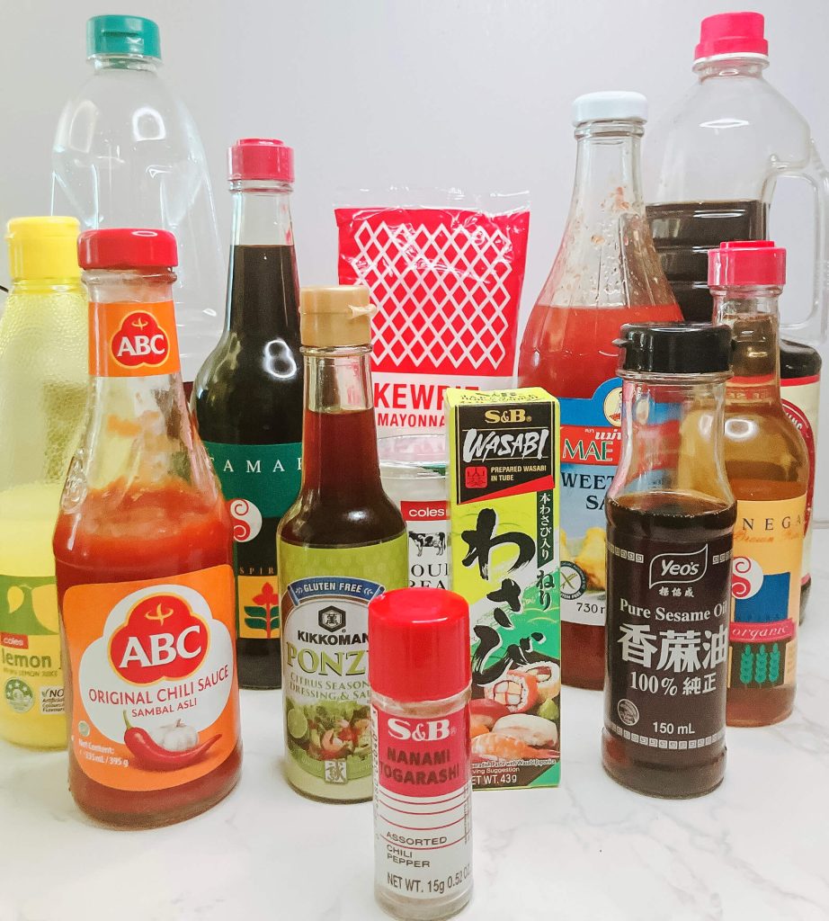 Ingredients for karaage chicken dipping sauces including soy sauce, ponzu, Japanese mayo, shichimi togarashi, sour cream, and chili sauces