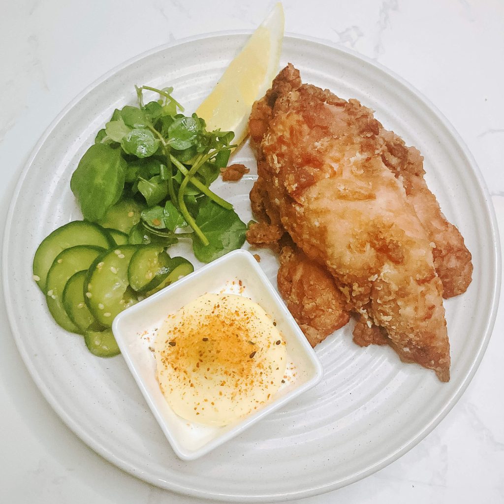 Air fryer karaage chicken tenderloin served with quick cucumber pickles, dipping sauce, and lemon wedge