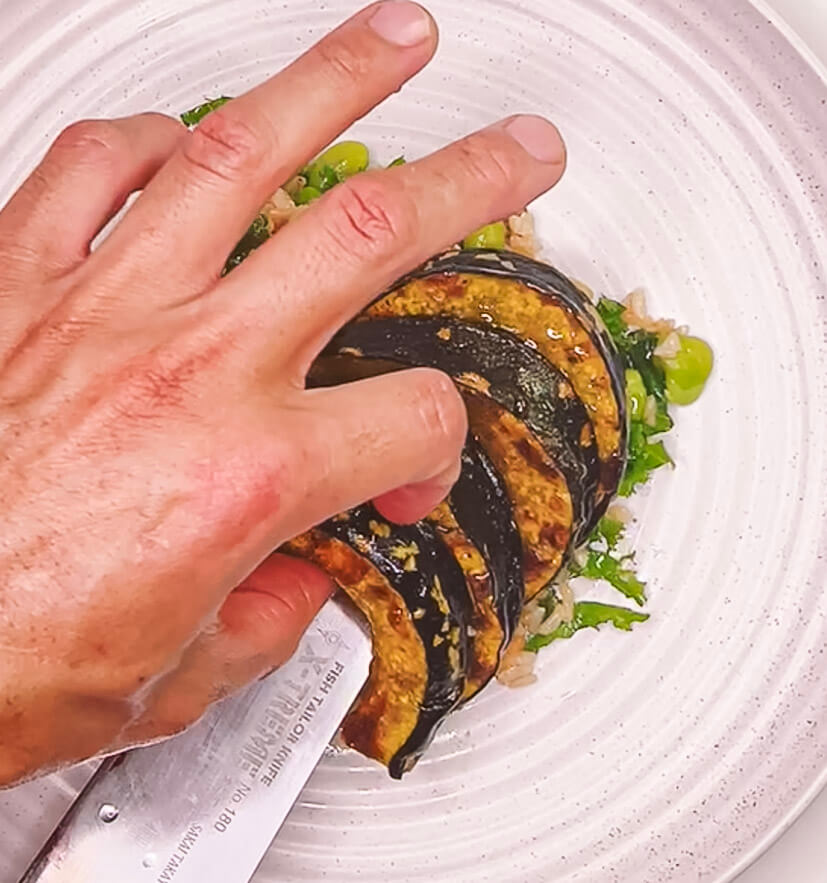 adding roasted pumpkin to brown rice salad