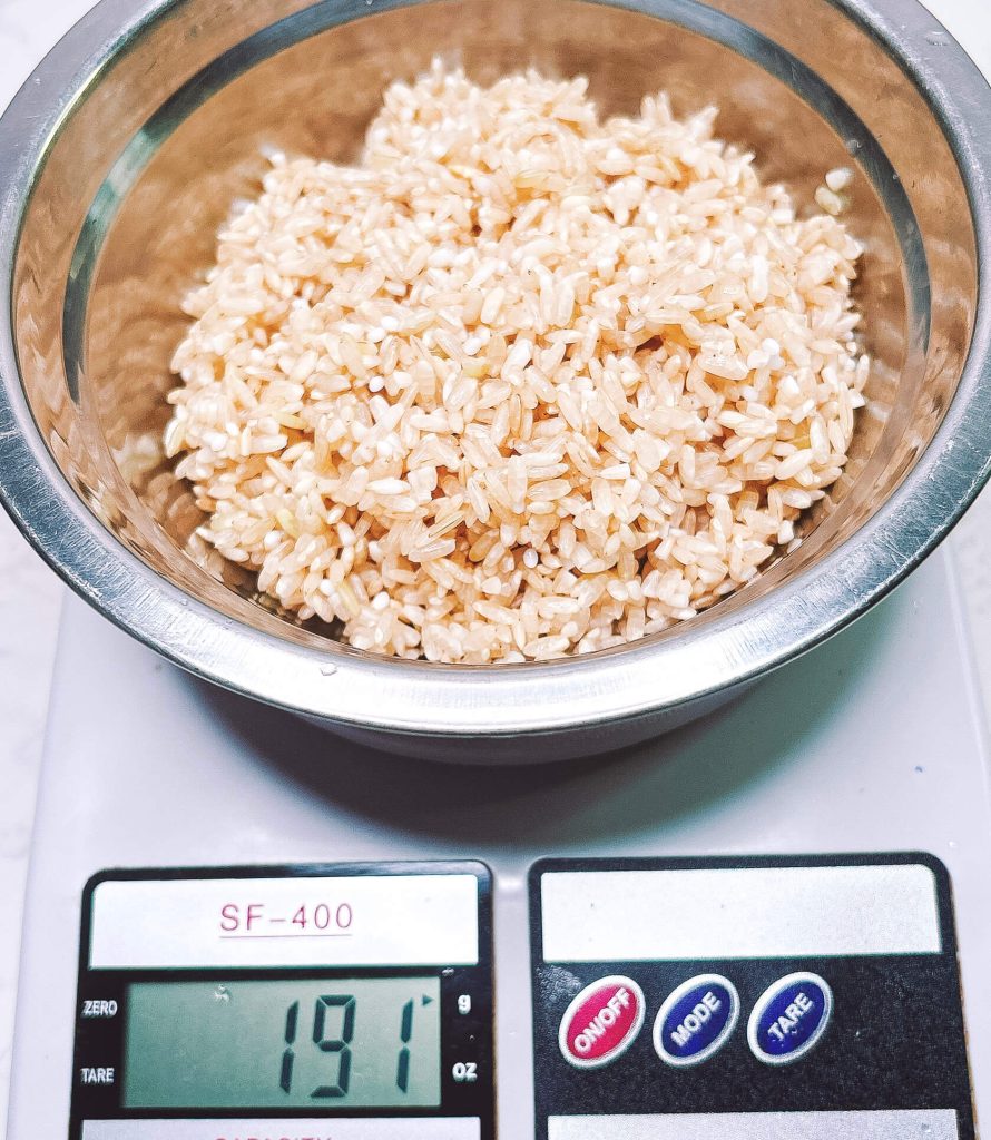 Brown rice after soaking showing increased weight on kitchen scale