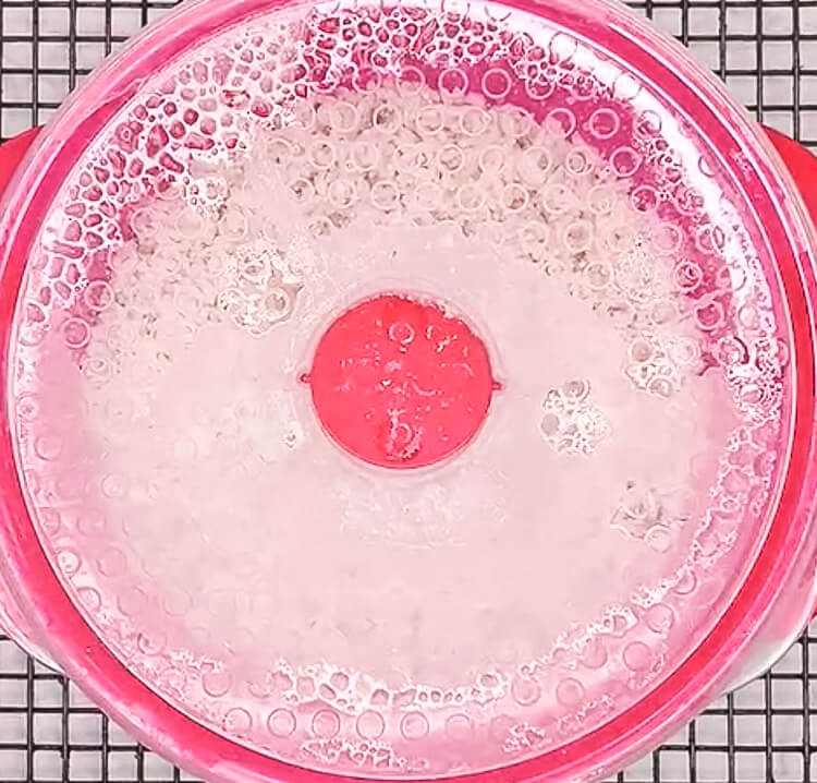 Brown rice resting in covered bowl after microwave cooking