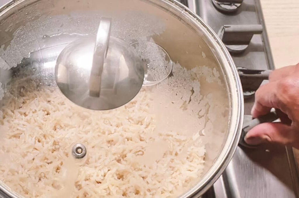 Brown rice with water absorbed ready to turn off heat on stovetop