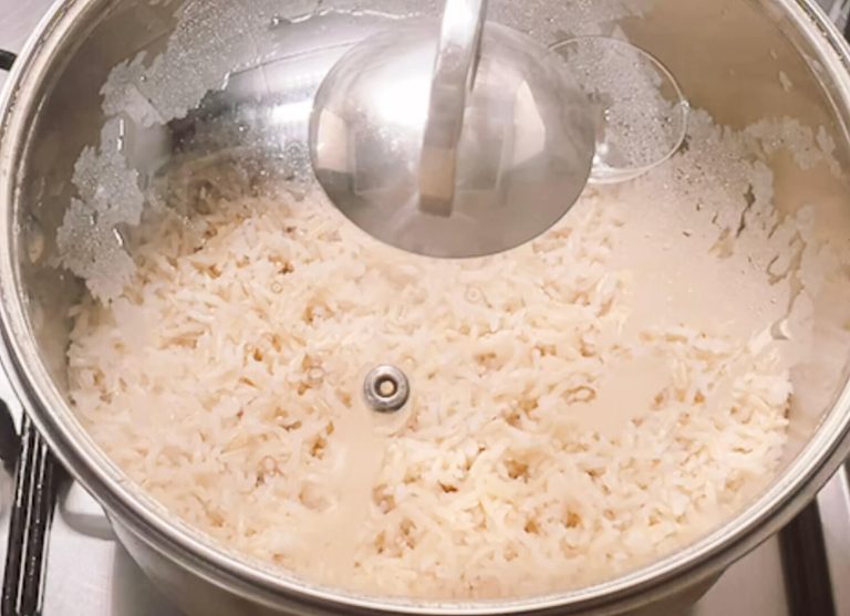 Brown rice with water absorbed in pot ready to turn off heat