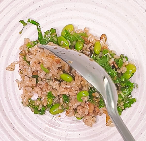 plating brown rice salad with kale pumpkin beetroot and Japanese onion dressing