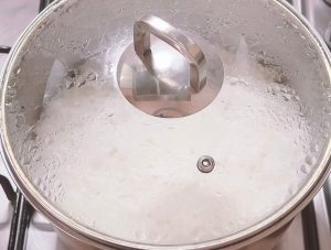 resting cooked white rice in a covered pot after cooking