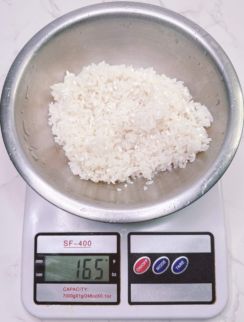 Cooked white rice weighed after rinsing to show water absorption