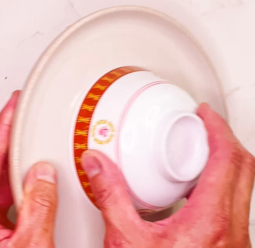Flipping moulded fried rice from bowl onto a plate