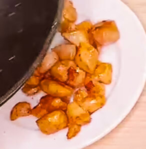 Cooked chicken set aside on plate for fried rice