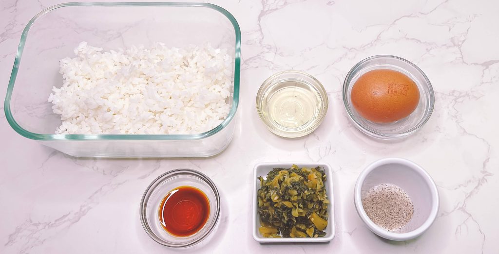 Takana fried rice ingredients including rice, egg, pickled mustard greens and seasoning